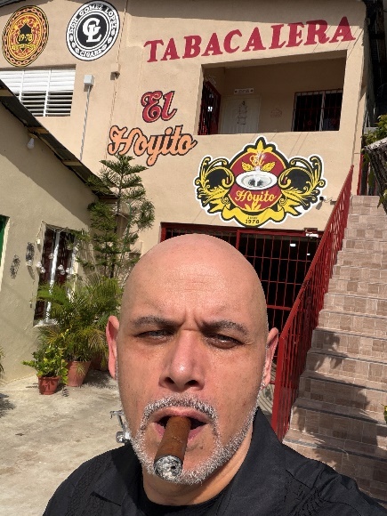 Enjoying a cigar outside the El Hoyito factory